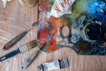 painting palette and paint brushes on wooden table