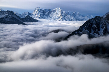 Obraz na płótnie Canvas Nepal, Himalayas, sunrise view from Gokio Ri peak at cloud sea over Gokio valley and mountains Tamserku and Kangtega. 