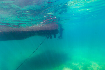 Submerged view of dive boat ladder anchor line and bottom of Lake Superior