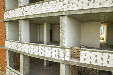 Rooms interior of new apartment building facade under construction.