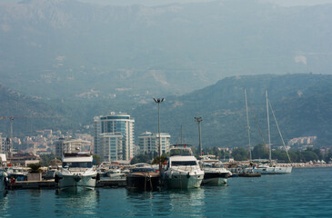 city port with pleasure boats, fishing boats and yachts near the old town of Budva, Montenegro, Adriatic sea