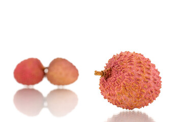 Three ripe organic litchi fruit, close-up, isolated on white.