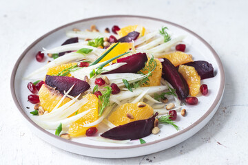 Salad with fennel, oranges, beets and pomegranate seeds with sauce