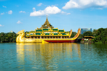 Yangon, Myanmar - view of Karaweik Palace reflected on the waters of Kandawgyi Lake