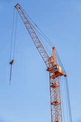 Construction crane. Red construction crane against a clear sky.