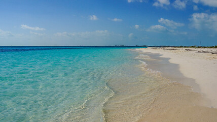 Cuba, February 2012, turquoise sea and white sand beach against blue sky