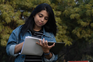 Fototapeta premium College student writing something on her notebook