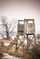 Wooden ambush in the field in winter	