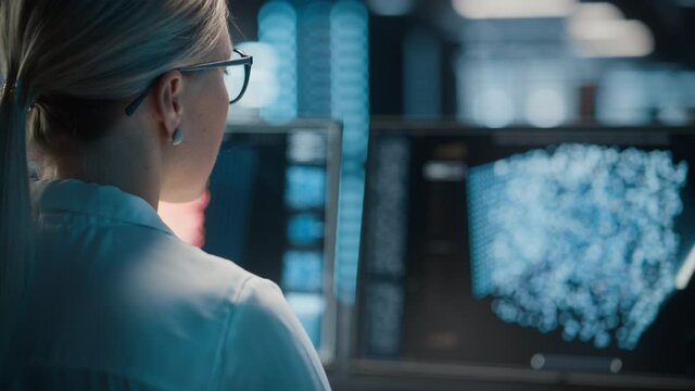 High-Tech Data Center Server Control: IT Specialist Administrator Working on Computer, Screen Showing Advancing Big Data AI Analysis. Web Services, Cloud Computing, Analytics Facility, Cyber Security