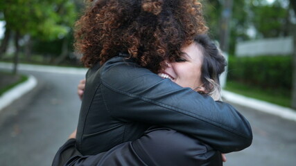 Friends embrace, two women hug, diversity concept