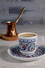a cup of Turkish coffee with coffee pot on the table
