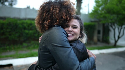 Friends embrace, two women hug, diversity concept