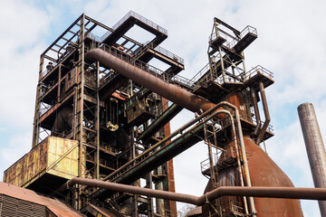 Metallurgical rusty tower with pipes.