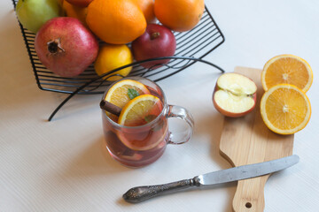 Fruit tea, various fruits in a basket on the table. Calendar 2022, winter mood and spruce branches.