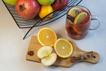 Fruit tea, various fruits in a basket on the table. Calendar 2022, winter mood and spruce branches.