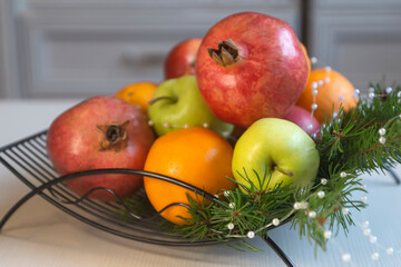 Fruit tea, various fruits in a basket on the table. Calendar 2022, winter mood and spruce branches.