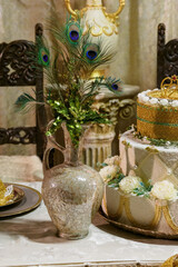 Peacock feathers in an ornamental vase.