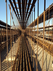 Irons on a construction site in the sun.
Rusty metal rods for reinforced concrete under sunlight.
Construction material for metal structures.