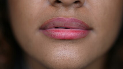 Naklejka premium Macro close-up person mouth. Black Brazilian girl lips, face detail, natural casual woman