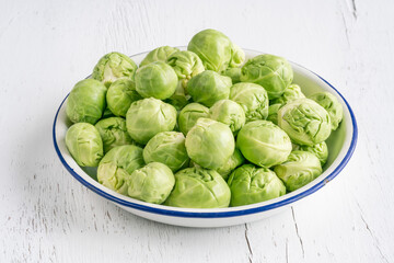 Brussel sprouts in a bowl on wooden table