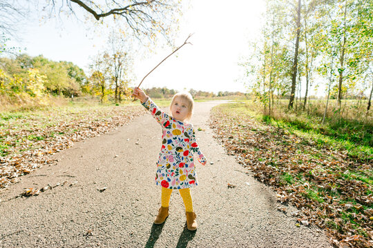 Full length view of a toddler playing with a stick in a park