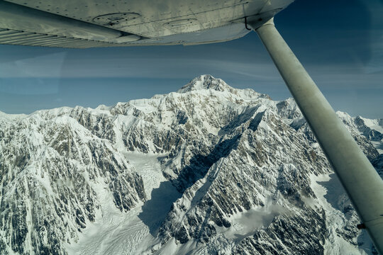 Beautiful snow covered mountains seen from small airplane
