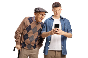 Elderly man looking at a young man typing on a mobile phone