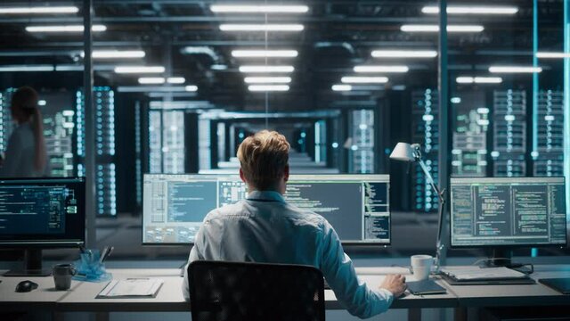 High-Tech Data Center: IT Specialist System Administrator Monitoring Server. Infrastructure Architect Works on Web Services, Cloud Computing, Analytics. Data Scientist Does Cyber Security Maintenance