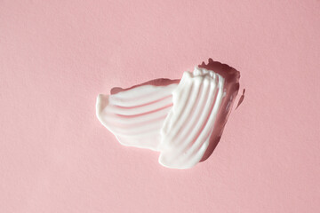 White cream texture on a powdery background. Flat lay.