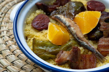 Bread crumbs with chorizo, green pepper, orange, bacon and fried anchovies. Traditional Spanish tapa.