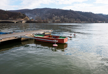 Fototapeta na wymiar Boat anchored near a floating wooden pontoon. Boat on the river.