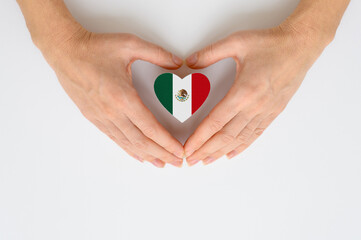 The national flag of Mexico in female hands. The concept of patriotism, respect and solidarity with...