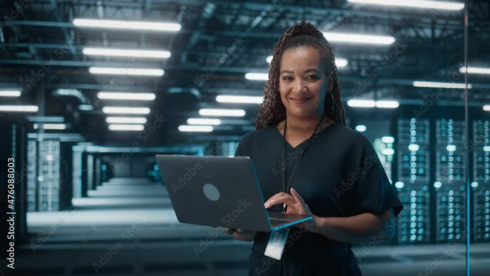 Aufkleber Portrait of Successful African American Female IT Specialist Using Laptop, Standing in Data Center. System Administrator Works on Web Services. Cloud Computing, Server Analytics, Cyber Security