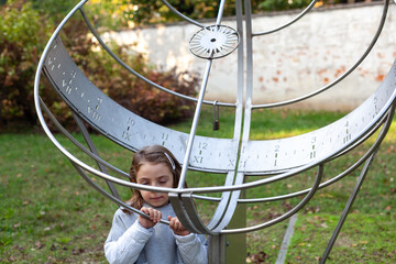 Cute Caucasian kid playfully posing in the park in autumn