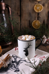 Cocoa with marshmallows and citrus zest on christmas background