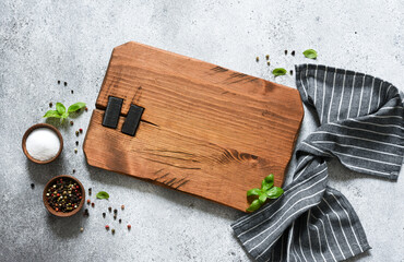 Wooden board with spices, basil. Food background with place for text.