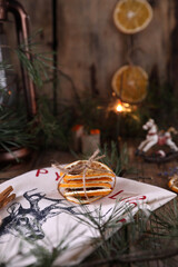 Christmas decorations and coniferous branches on wooden background