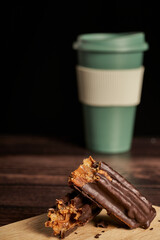 churro filled with dulce de leche and dipped in chocolate, cut in half