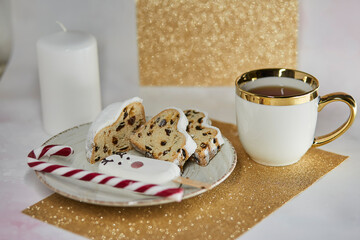 Luxury tea cup, cute marshmallow deer, Christmas stollen and caramel stick. Beautiful tea time. Christmas inspiration concept. Good morning or tea party concept. Good mood, tea time aesthetic