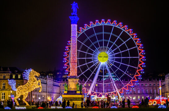 Stuttgart, Germany - December 17: Visitors at the annual exhibition of illuminated symbols at the Christmas market in the old town of Stuttgart on December 17, 2021