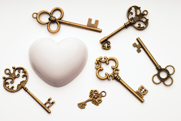 Aged keys and heart. Search for understanding, reciprocity in love and relationships, concept