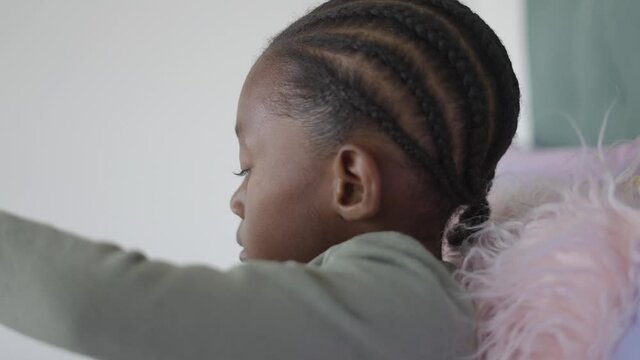 Black Girl with Cornrows Reading a Book