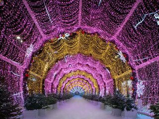 Beautiful New Year's tunnel of lights at night. Snow-covered road. Moscow, Russia, New Year city...