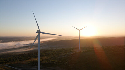 Wind power plant at sunrise. Aerial photography