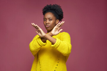 Serious young african american woman show stop finish gesture by crossed hands, protest against racial discrimination