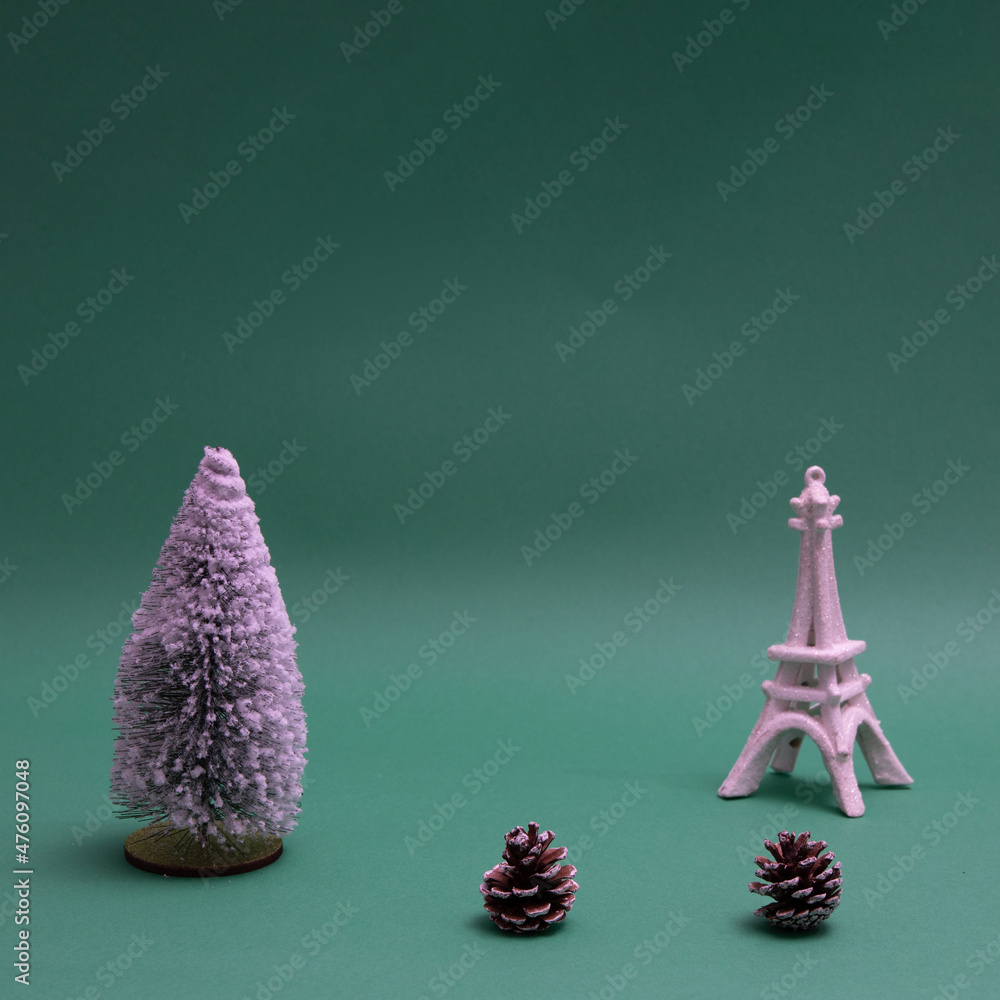 Poster new year's tree sprinkled with snow with cones and an imitation of the eiffel tower