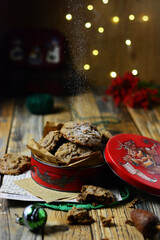 Christmas Chocolate chip cookies for Santa Clause on wood background, copy space , red biscuit box , bokeh lighting