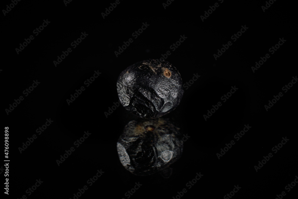 Poster metallic asteroid 3d rendering reflecting over a shiny black background