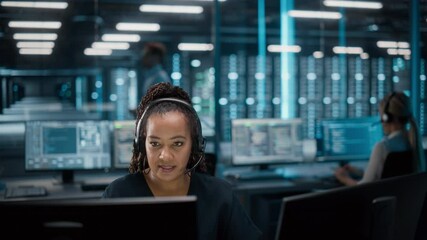 Call Center Office: Portrait of Friendly African American Female Technical Customer Support Specialist Talking on a Headset, uses Computer. Client Experience Officer Helps Online via Video Conference