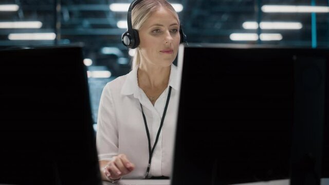 Call Center Office: Portrait of Friendly Caucasian Female Technical Customer Support Specialist Talking on a Headset, uses Computer. Client Experience Officer Helps Online via Video Conference